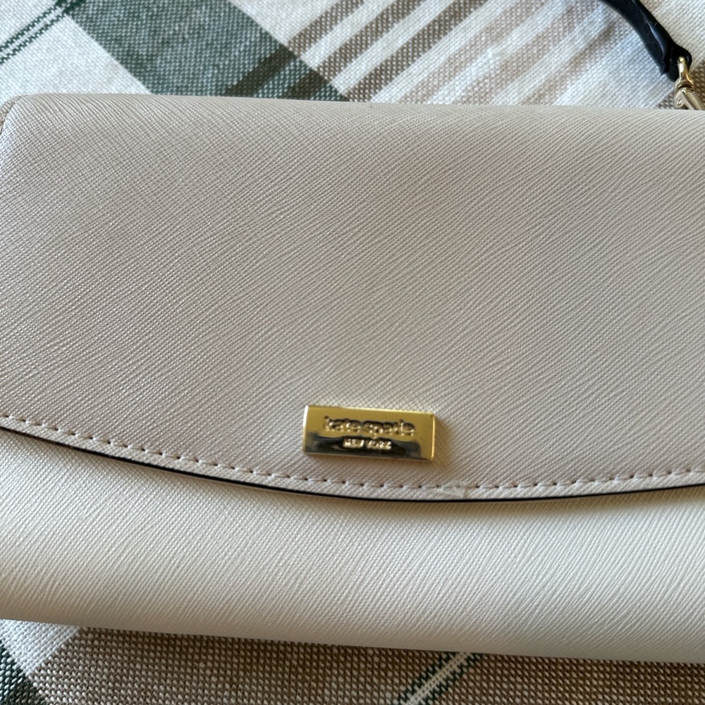 Kate Spade Cream Wristlet with Minimalist Design